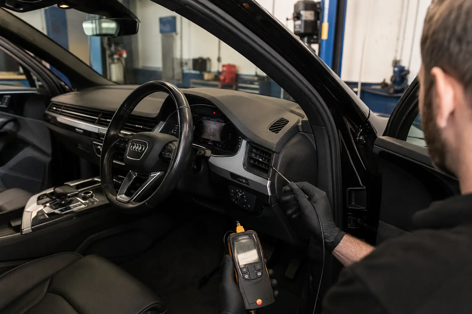 Audi vent temperature being checked during an AC assessment
