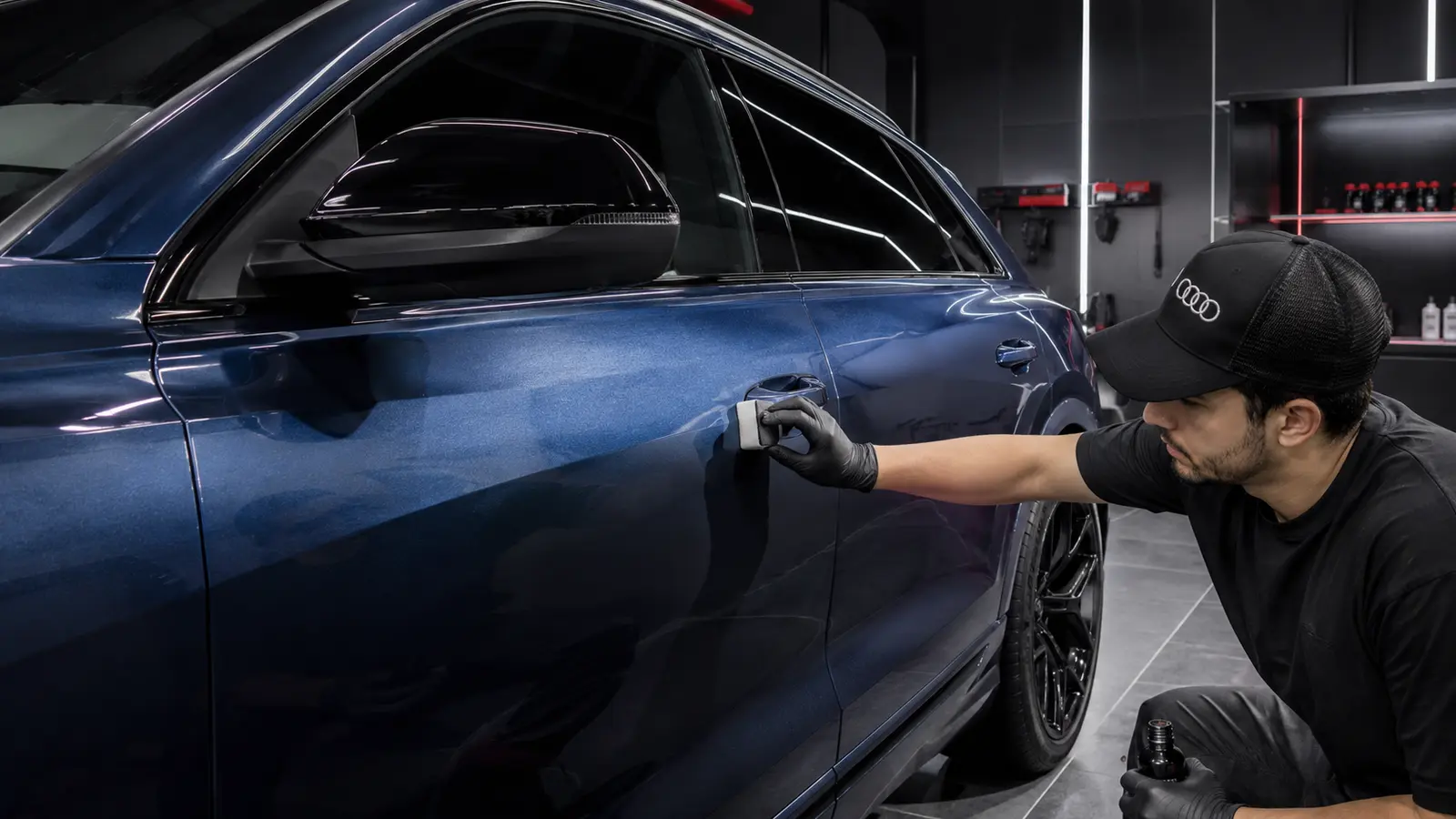 Technician applying ceramic coating to an Audi panel