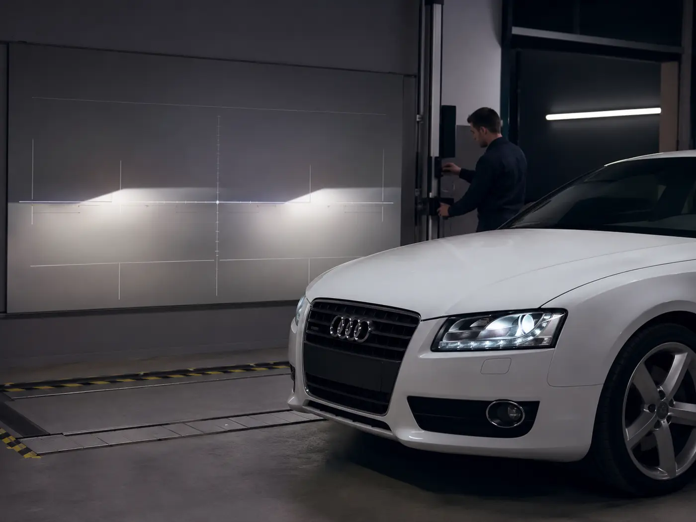 Audi headlight beam pattern being checked on an aiming screen