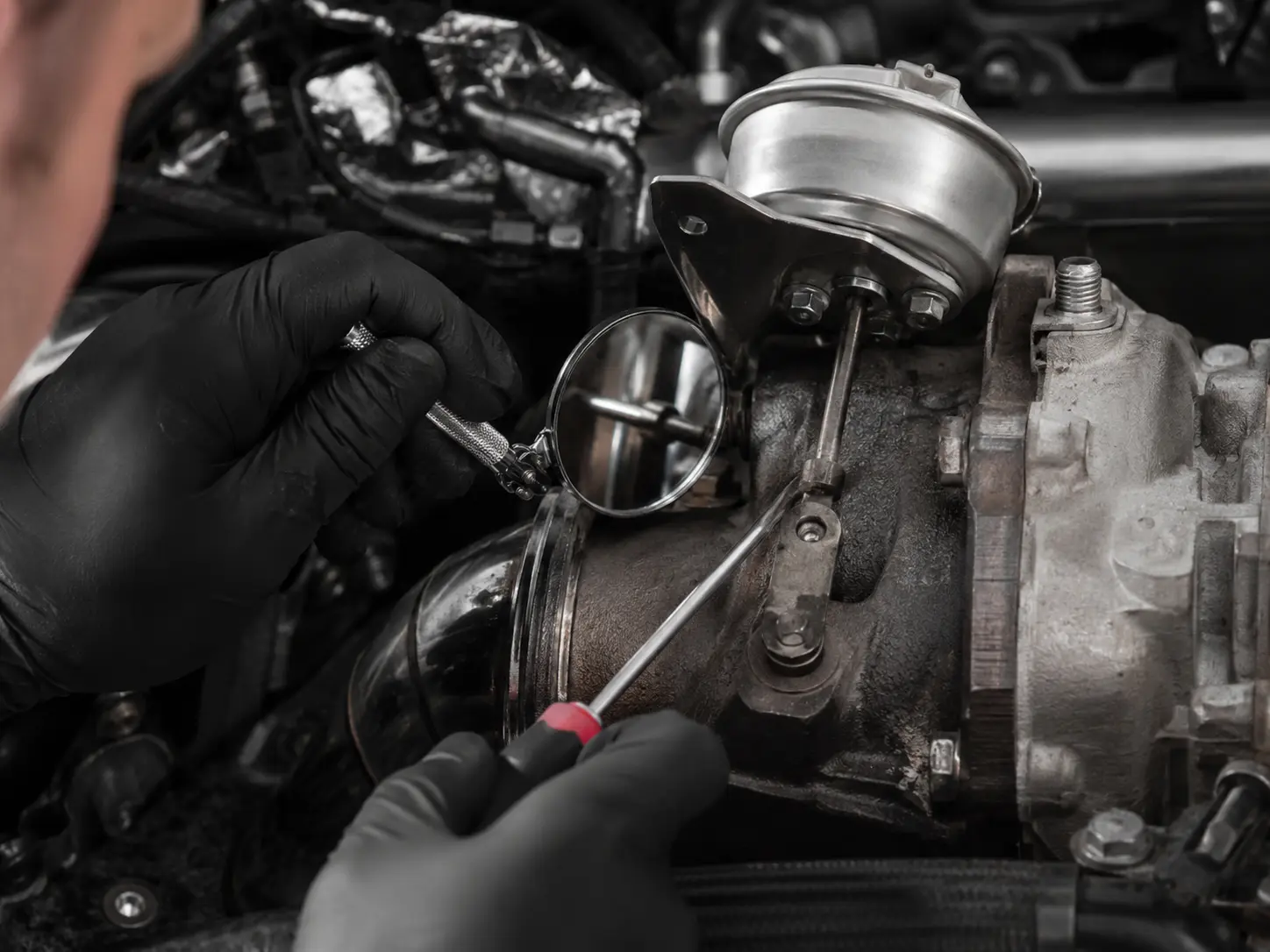 Close inspection of a turbocharger wastegate actuator and linkage